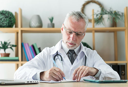 Doctor Writing a CPAP Prescription